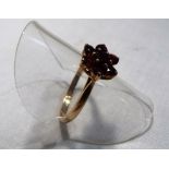 A lady's hallmarked 9 carat yellow gold and garnet daisy cluster ring, approx weight 2.