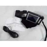 A digital 4x magnifier with cables, manu