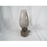 A Victorian oil lamp with glass reservoir and diffuser,