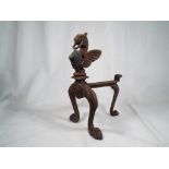 An early single wrought iron fire dog with ring loop top for tying dog to,