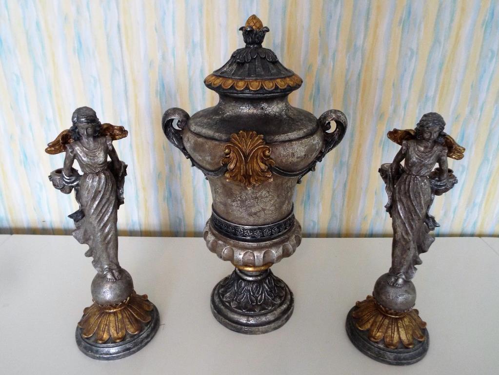 An ornamental lidded urn, 52 cm (h) and a matched pair of candle holders in the form of cherubs,