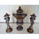 An ornamental lidded urn, 52 cm (h) and a matched pair of candle holders in the form of cherubs,