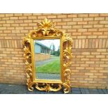 A large good quality bevel-edged wall mirror with ornate gilded frame,