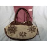 A good quality Radley handbag, cream and biscuit colour with a floral decoration,