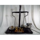 A set of scales by W & T Avery of Birmingham 55 cm (h) x 51 cm (w) together with a set of weights