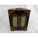 A good quality Chinese wooden jewellery box with brass detailing inset with pierced jade decoration,