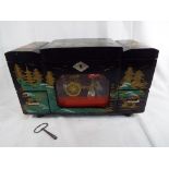 A hand painted 1950's Japanese black lacquered musical jewellery box with moveable celluloid