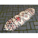 A wooden hand-painted tribal shield 132 cm (h) x 41 cm (w)