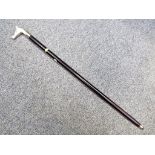 A good quality walking cane with a white metal handle depicting a horses head,