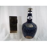 A ceramic Royal Salute Scotch whisky bottle 23 cm (h) and a Sarome rectangular table lighter 12.
