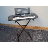 A Yamaha Portatone PSR-78 electronic keyboard on stand with manuals, lead and transformer,