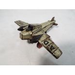 An early 20th century tin-plate clockwork toy Aeroplane, wingspan 11.