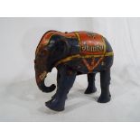 An early 20th century tin-plate clockwork toy Elephant marked Jumbo, with key,