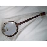 A five string banjo with peg and short string removed,