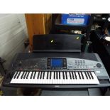 A Yamaha PSR-8000 portable electronic keyboard with stand