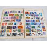 A Trafalgar stamp album containing quantity of UK and Worldwide postage stamps,