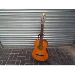 A six string acoustic guitar,