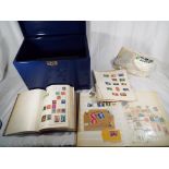 Two stamp albums containing a collection of UK and Worldwide postage stamps,