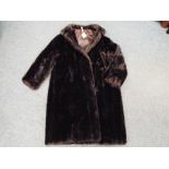 A dark brown faux fur lady's coat