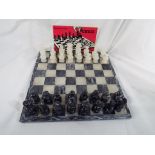 A complete alabaster chess set on a marble base and other, height of king 7.