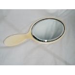 An early 20th century ivory backed bevel-edged hand mirror,