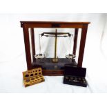 A scientific weighing balance with two boxes of weights, the scales marked Griffin & George Ltd,