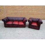 A red leather Chesterfield three-seater settee and a further red leather Chesterfield armchair -