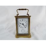An early 20 th century French carriage timepiece with alarm, the brass case with four glazed panels,