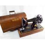 A Singer sewing machine with wooden case