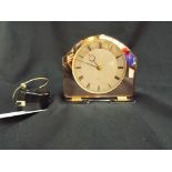 A Smiths Setric art deco rose glass mantle clock with Roman numerals.