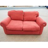 A sofa bed upholstered in salmon