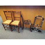 A pair of chairs with rattan seats,