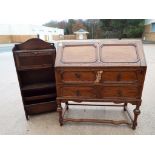 A 1920's oak fall front bureau, 98 cm x 89 cm x 40 cm and an oak magazine rack,