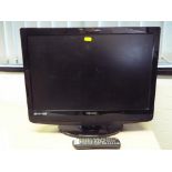 A 22" Technika flat screen TV with remote control.