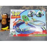 A Disney Toy Story slot racing set micro Scalextric and a soft toy chimpanzee