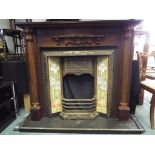 A fire surround with cast iron fire place and tiled surround seated on a slate base,