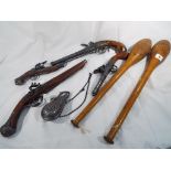 A pair of wooden clubs and a quantity of wall hangers (qty)