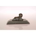 A CHINESE BRONZE OF A CHILD, cast on all fours clutching a piece of fruit.