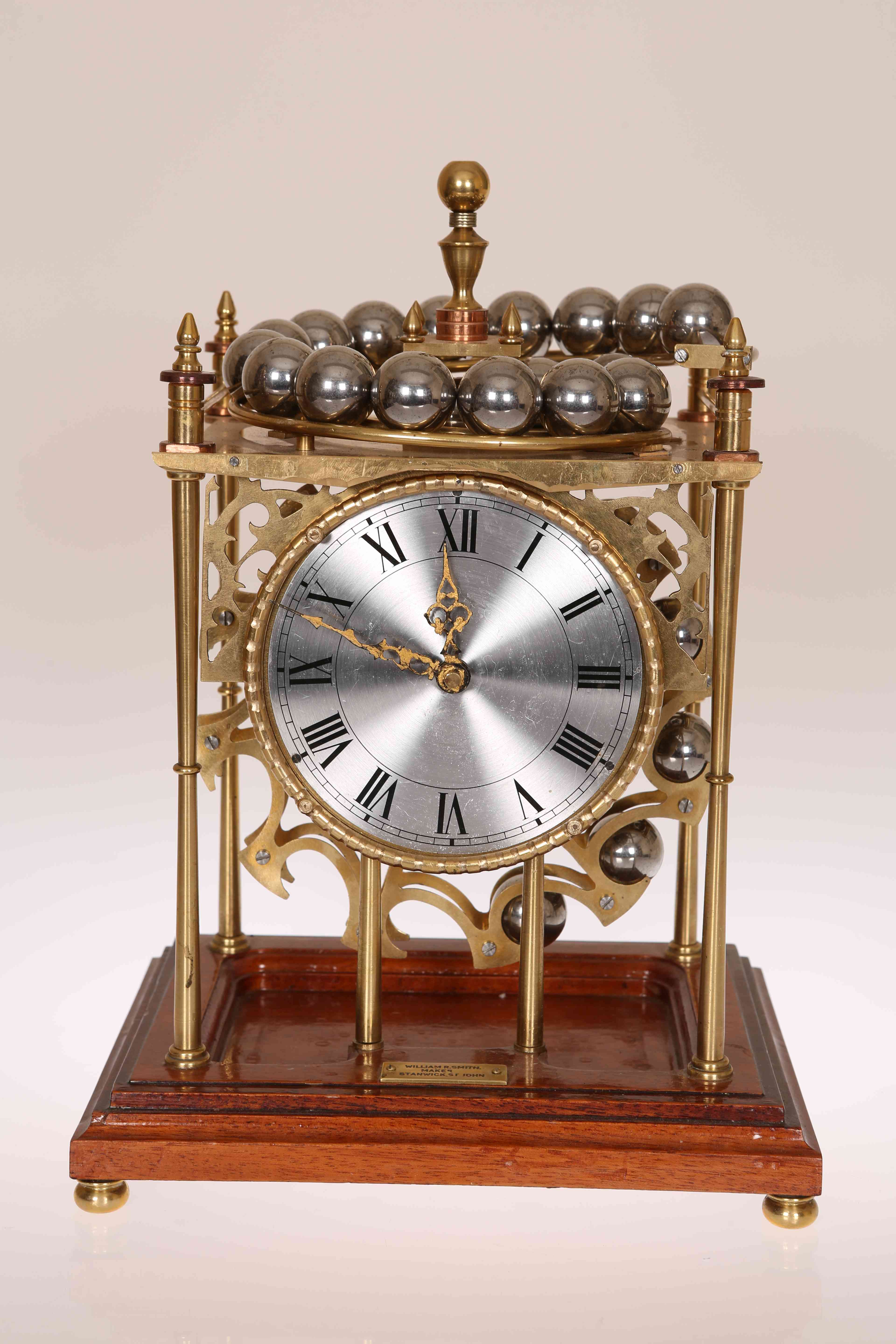 A BRASS BALL BEARING GRAVITY CLOCK BY WILLIAM R.