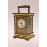 A SMALL BRASS CASED CARRIAGE CLOCK, late 19th/ early 20th Century, with circular dial,