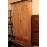 Pine fitted cupboard having two arched panel doors above two drawers