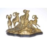 Brass model of four goats on rocky outcrop