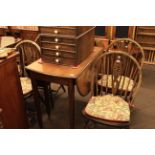 Mahogany drop leaf dining table and four wheelback dining chairs