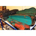 Collection of ten violin cases containing seven Chinese violins