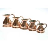 Five graduated copper jugs