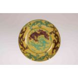 A CHINESE YELLOW GROUND SAUCER DISH, painted with dragons. 13.