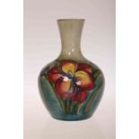 A MOORCROFT POTTERY VASE, tubelined and hand painted with Freesia, impressed marks.