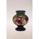 A MOORCROFT POTTERY VASE, tubelined and hand painted with Orchids, impressed marks. 9.