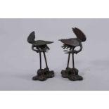 A PAIR OF JAPANESE BRONZE MODELS OF CRANES, MEIJI PERIOD, each cast standing on a naturalistic base,