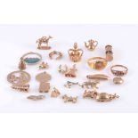 A COLLECTION OF TWENTY FIVE GOLD CHARMS, to include two gold rings, the charms including animals,